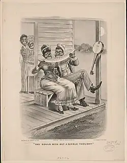 Couple sharing watermelon, banjo hangs nearby