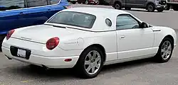 Rear 3/4 view of a white hardtop convertible