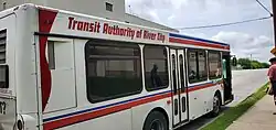 White, red and blue bus