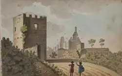 Ruin of a castle with crenulated tower in the foreground