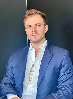 Picture of Alex Klokus in a blue suit.