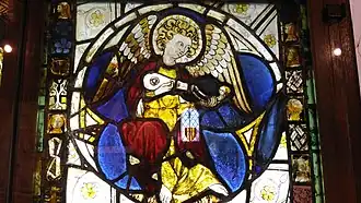 Representation of a player of the gittern, a type of guitar, in an individual medallion.