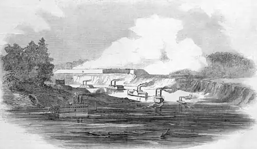 Black-and-white depiction of military ships in a bend in a river, with a fort on the bluffs. Smoke rises from the fort