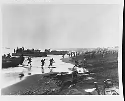 Soldiers unloading landing craft on the beach at Massacre Bay, Attu, on 12 May 1943.