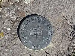 Survey marker at the summit of Breccia Peak.