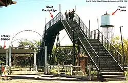 The footbridge allowed trolley passengers to safely cross the train tracks into the park; it was a major attraction for youngsters who ascended to view the approaching smoke-billowing trains (1952).