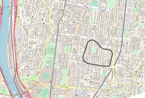 Map showing modern street layout using Open Street Map graphics, overlaid with an outline of the old racetrack.