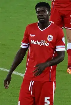 A footballer wearing an all red kit.