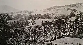 Train on trestle bridge of California and Nevada Railroad