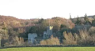 View across fields to castle on a ridge.