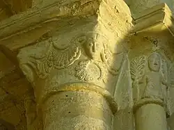 Capital showing human faces and ferns