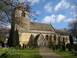 A church and churchyard, with the tower on the left