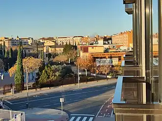Urban view of Ciudad Real featuring a street in the foreground and buildings behind