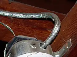 A photo of older cloth-sheathed NM cable.