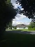 Community Centre. Tree line divides two townlands.