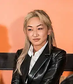 head and shoulders crop of Guo on stage at Strictly VC event in 2024