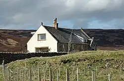 A converted church partly obscured by the ground.