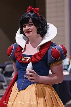 Woman with black hair and light skin cosplaying as Snow White at Disneyland