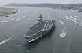 Sailors aboard Ronald Reagan man the rails as the supercarrier arrives at her new homeport in San Diego, California, on 23 July 2004.