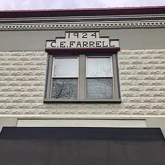 Window detail showing Farrell's name and the construction date