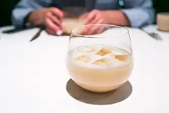 A glass of horchata with ice.