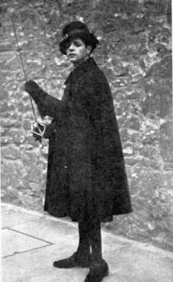 young clean-shaven white man in dark 17th-century costume with rapier in his hand