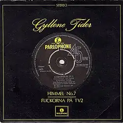 The sleeve for the Himmel No. 7/Flickorna på TV2 single release, with the name Gyllene Tider in a yellow script on top and the names of the tracks on the bottom, a Parlophone logo, and a yellow border with the word "Stereo" up top