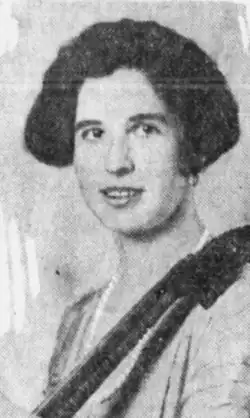 Gough, a smilig young white woman with dark bobbed hair, posing with a cello