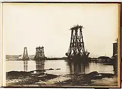 Black and white photograph of the construction of the cantilevers of the Forth Bridge