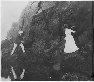Franklin Roosevelt climbing rocks with friends (1902)