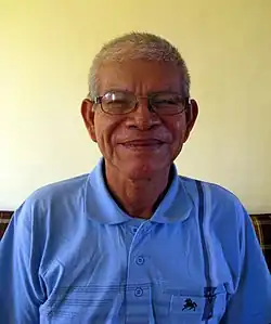 Guillermo Arévalo Valera wearing a blue polo shirt, smiling at camera