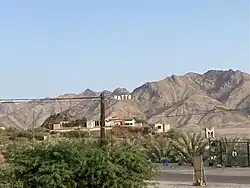 The Hatta sign with the Al Hajar Mountains in the background