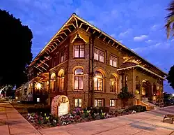 Brick building with arched windows and a roof that juts out to provide some shade
