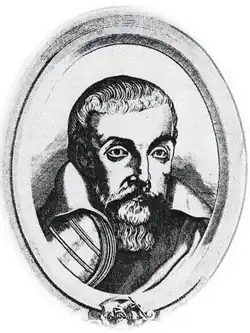 A black and white portrait, from the chest up, of a middle-aged man