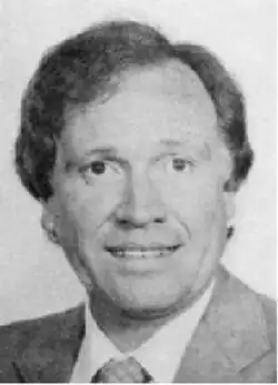 formal portrait of caucasian male with shirt wavy hair, wearing a suit and tie