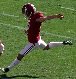 American football placekicker about to kick a football.