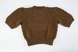 Photo of a brown shirt knit with patterns on it