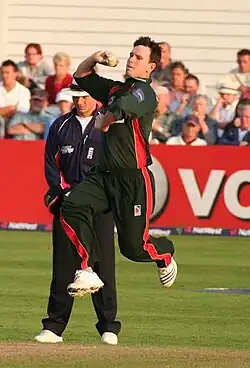 Jim Allenby bowling; he must ground some part of his foot behind his popping crease and within the return creases for the ball to be a legal delivery. As a member of the fielding side, he can also – after delivering the ball – attempt to run out a batsman by breaking the stumps with the ball before the batsman manages to return to the popping crease.[1][6]