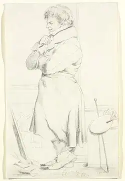 Standing man looking at a painting