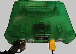 A translucent green Nintendo 64 console with four controller ports in its front.