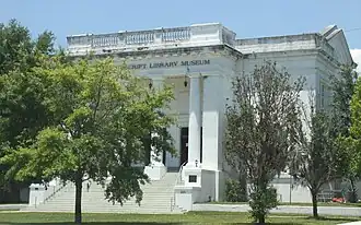 Facade of imposing building with Greek columns.