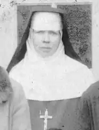 A colorless photograph of a woman wearing the habit of a nun and a cross on her chest.
