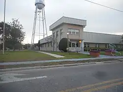 The Lake Alfred City Hall with the Downtown Water Tower in the background, in April 2023.