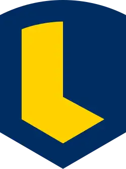 A blue escutcheon with straight parallel sides ending in a lozenge shape is charged with a sans-serif letter "L".