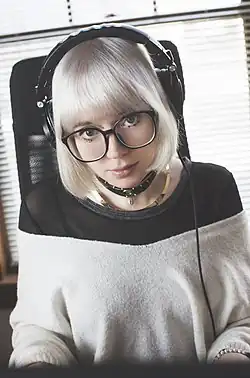 Lena Raine promotional photo, 2018, wearing headphones