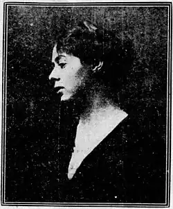 Grainy black-and-white photograph of young woman with light skin and dark hair