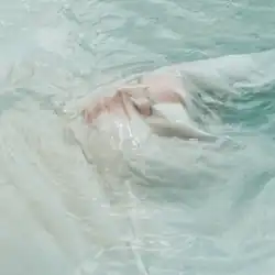 Maye floating on water with a transparent cloth over her