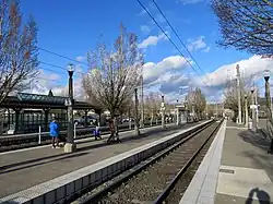 People waiting on a light rail platform