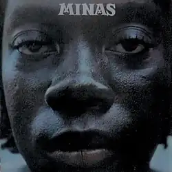 A close-up photo of Milton Nascimento's face, with the text "Minas" at the top.