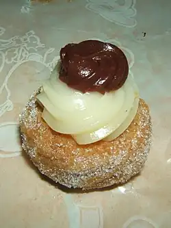 Zeppole consists of a deep-fried dough ball, dusted with powdered sugar and sometimes filled with various sweets.